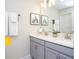 Bathroom featuring double sinks, gray cabinets, and modern decor at 218 Ocean Course Ave, Davenport, FL 33896