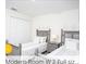 Cozy bedroom featuring two beds and a neutral color scheme at 218 Ocean Course Ave, Davenport, FL 33896
