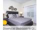 Comfortable downstairs bedroom with a decorative metal headboard and lamps at 218 Ocean Course Ave, Davenport, FL 33896