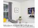 Modern bedroom with a TV, neutral walls and simple decor, offering a serene and uncluttered space at 218 Ocean Course Ave, Davenport, FL 33896