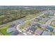An aerial shot displays a beautiful neighborhood with well-manicured lawns and tree-lined streets at 2312 Datura Loop, St Cloud, FL 34772
