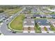 Aerial view of homes in a community with well-manicured lawns, landscaping, and paved roads at 2312 Datura Loop, St Cloud, FL 34772