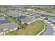 Aerial view of neighborhood featuring many homes with dark roofs and green grass at 2312 Datura Loop, St Cloud, FL 34772