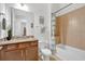 Bathroom featuring warm wall tiles, a shower-tub combo, and a granite vanity at 2312 Datura Loop, St Cloud, FL 34772