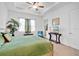 Comfortable bedroom featuring a ceiling fan, plush carpeting, a comfortable bed, and plenty of natural light at 2312 Datura Loop, St Cloud, FL 34772