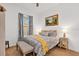 Cozy bedroom with a patterned bedspread, soft lighting, and charming decor at 2312 Datura Loop, St Cloud, FL 34772