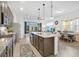 Modern kitchen featuring an island and seamlessly connects to a sunny dining area at 2312 Datura Loop, St Cloud, FL 34772