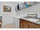 Bright laundry room with a washer, dryer, granite countertop, and cabinet sink at 2312 Datura Loop, St Cloud, FL 34772