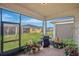 Relaxing screened-in patio with comfortable furniture and a view of the backyard at 2312 Datura Loop, St Cloud, FL 34772