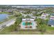 Community pool surrounded by palm trees and seating area near lake and residential homes at 2312 Datura Loop, St Cloud, FL 34772