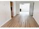 Hallway with hardwood flooring leading into a naturally lit living room at 236 Eldorado Dr, Debary, FL 32713