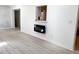 Open-concept living room with modern fireplace, bright walls and lovely flooring at 236 Eldorado Dr, Debary, FL 32713