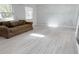 Spacious living area with whitewashed brick wall, lovely flooring and large windows at 236 Eldorado Dr, Debary, FL 32713