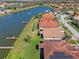 Picturesque aerial image of lakeside homes, featuring lush green yards and private docks along a calm waterway at 2541 Shoal Bass Way, Kissimmee, FL 34746