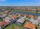 Breathtaking aerial perspective featuring beautiful homes with pools and red-tiled roofs, nestled by a serene lake at 2541 Shoal Bass Way, Kissimmee, FL 34746