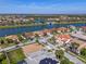 Scenic aerial shot showcases homes with solar panels along a lake, highlighting community living and water views at 2541 Shoal Bass Way, Kissimmee, FL 34746