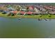 Lakeside houses feature private boat docks and pristine lawns, offering direct access to the water at 2541 Shoal Bass Way, Kissimmee, FL 34746
