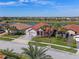 Aerial view of a beautiful home with a tile roof, well-manicured lawn, and lush landscaping at 2541 Shoal Bass Way, Kissimmee, FL 34746