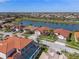 Stunning aerial view of waterfront homes with red tile roofs and lush landscaping in a well-maintained community at 2541 Shoal Bass Way, Kissimmee, FL 34746