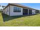 Home backyard featuring a manicured lawn, screened lanai, and beautiful landscaping at 2541 Shoal Bass Way, Kissimmee, FL 34746