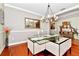 Dining room with hardwood floors, modern chandelier, decorative mirror and view of foyer console table at 2541 Shoal Bass Way, Kissimmee, FL 34746