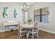 Cozy dining area with wood floors, modern chandelier, and natural light at 2541 Shoal Bass Way, Kissimmee, FL 34746