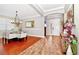 Elegant dining area featuring hardwood floors, stylish chandelier, and ample natural light at 2541 Shoal Bass Way, Kissimmee, FL 34746