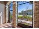 Cozy screened porch with stone pillars and beautiful landscaping views at 2541 Shoal Bass Way, Kissimmee, FL 34746