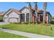 Attractive single-story house with a terra cotta roof, three-car garage, and well-kept lawn at 2541 Shoal Bass Way, Kissimmee, FL 34746