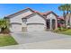 Attractive home featuring a terra cotta roof, three-car garage, and lush landscaping at 2541 Shoal Bass Way, Kissimmee, FL 34746