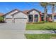 Lovely home boasting a terra cotta roof, a spacious driveway, and manicured landscaping at 2541 Shoal Bass Way, Kissimmee, FL 34746