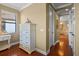 Bright hallway with hardwood flooring and elegant decor leading to the main bedroom and bathroom at 2541 Shoal Bass Way, Kissimmee, FL 34746