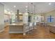 Open-concept kitchen with granite countertops, stainless steel appliances, and a large island with seating at 2541 Shoal Bass Way, Kissimmee, FL 34746