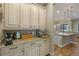 A butler's pantry provides ample storage with custom cabinetry and granite countertops at 2541 Shoal Bass Way, Kissimmee, FL 34746