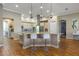 A kitchen island offers a breakfast bar with additional prep space, enhanced with modern pendant lighting at 2541 Shoal Bass Way, Kissimmee, FL 34746