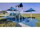 Well-maintained playground with slides and climbing features on a green lawn at 2541 Shoal Bass Way, Kissimmee, FL 34746