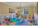 Vibrant playroom featuring soft tile flooring, a chandelier, and various toys and decorations at 2541 Shoal Bass Way, Kissimmee, FL 34746