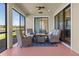 Inviting screened patio features comfortable seating with a lovely lake view at 2541 Shoal Bass Way, Kissimmee, FL 34746