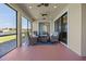 Inviting screened patio features comfortable seating with a lovely lake view at 2541 Shoal Bass Way, Kissimmee, FL 34746