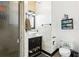 Bathroom with tiled shower, black vanity, and open storage at 2747 Kissimmee Bay Cir, Kissimmee, FL 34744