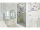Bright bathroom with a glass shower, a jacuzzi tub, and luxury finishes at 2747 Kissimmee Bay Cir, Kissimmee, FL 34744