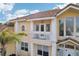 Attractive two-story home features a small balcony and elegant architectural details, with tile roof at 2747 Kissimmee Bay Cir, Kissimmee, FL 34744