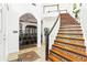 Bright foyer with a decorative staircase, tile floor and open view to the formal dining room at 2747 Kissimmee Bay Cir, Kissimmee, FL 34744
