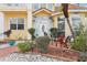 Charming front porch with seating, garden and elegant entryway on a well landscaped lot at 2747 Kissimmee Bay Cir, Kissimmee, FL 34744