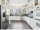 Bright kitchen with stainless steel appliances, white cabinets, and dark backsplash at 2747 Kissimmee Bay Cir, Kissimmee, FL 34744