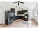 Functional kitchen featuring dark cabinetry, modern appliances, and tile flooring at 2747 Kissimmee Bay Cir, Kissimmee, FL 34744