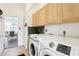 Well-equipped laundry area includes a washer, dryer, cabinets, and granite counters for added convenience at 2747 Kissimmee Bay Cir, Kissimmee, FL 34744