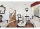 Bright living room with ornate styled furniture, decorative mirrors, hardwood floors and staircase in the background at 2747 Kissimmee Bay Cir, Kissimmee, FL 34744