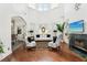 Bright living room with fireplace, hardwood floors, and view of the dining area at 2747 Kissimmee Bay Cir, Kissimmee, FL 34744