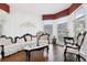 Bright living room with an ornate designed sofa and chairs set with hardwood flooring and natural light at 2747 Kissimmee Bay Cir, Kissimmee, FL 34744